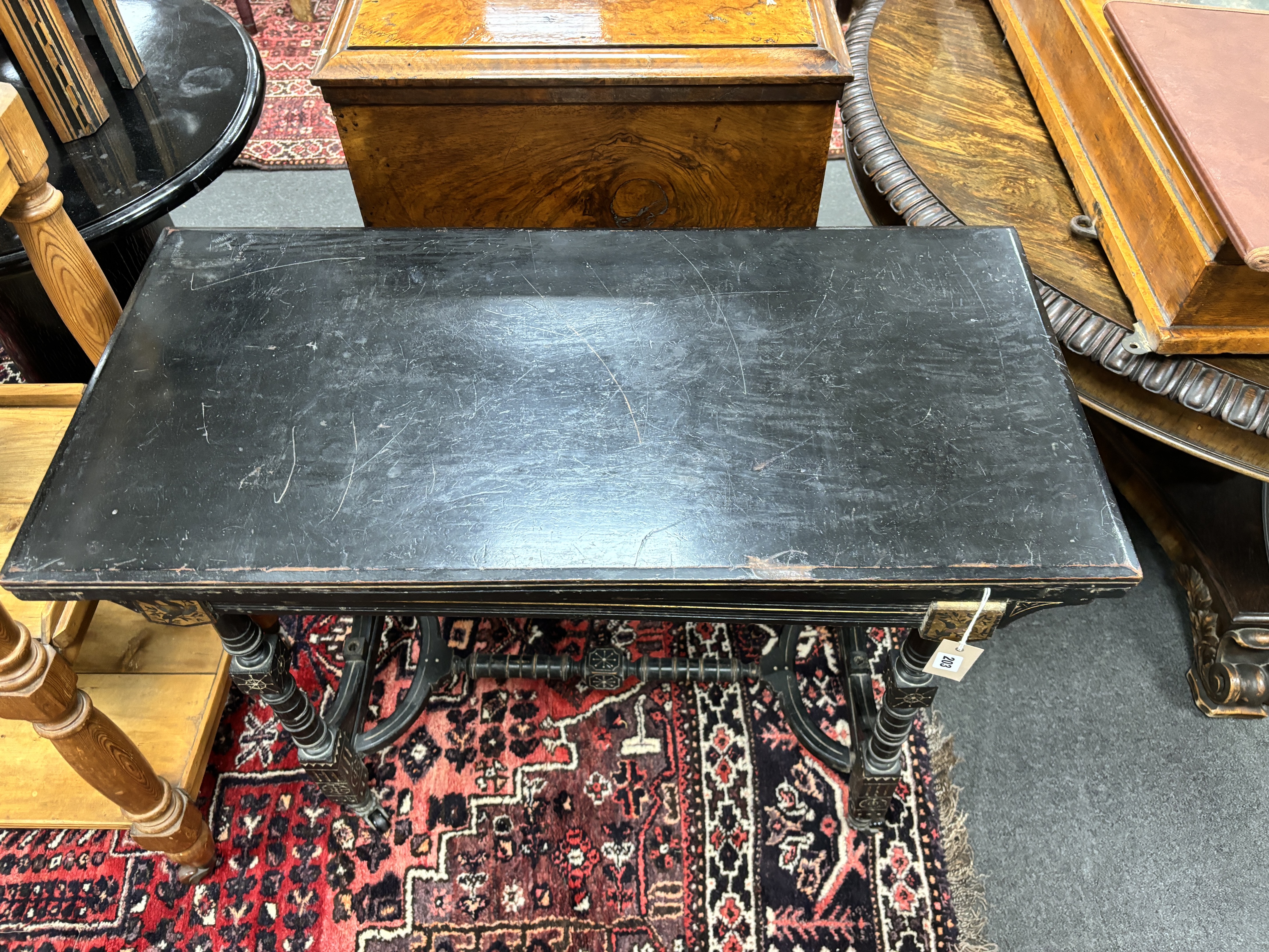 A late Victorian aesthetic movement ebonised folding card table, width 92cm, depth 44cm, height 76cm